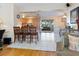 Open-concept kitchen with bar stool seating and view to the living and dining areas at 2376 Novus St, Sarasota, FL 34237