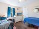 Bedroom with wood floors, blue accents, a desk, and a ceiling fan at 2376 Novus St, Sarasota, FL 34237