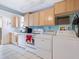 The laundry room features a washer, dryer, and lots of cabinets at 2376 Novus St, Sarasota, FL 34237