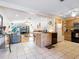 Open-concept kitchen with tile floors, an island, and an inviting breakfast bar at 2376 Novus St, Sarasota, FL 34237