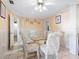 Bright dining room featuring tile flooring, a glass table, and patterned chairs at 2376 Novus St, Sarasota, FL 34237