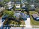 Aerial view of a single-Gathering home with solar panels, pool, and well-maintained landscaping at 2376 Novus St, Sarasota, FL 34237