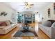 Spacious living room with hardwood floors, white couches, and a decorative rug at 2376 Novus St, Sarasota, FL 34237