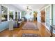 Sunlit living room featuring hardwood floors, stylish decor, and charming French doors at 2376 Novus St, Sarasota, FL 34237