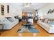 Bright living room with hardwood floors open to the kitchen and dining area at 2376 Novus St, Sarasota, FL 34237