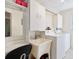 Bright laundry room with a utility sink, white cabinets, washer and dryer, and desk space at 2376 Novus St, Sarasota, FL 34237
