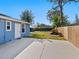 View of the backyard featuring a well-maintained lawn, patio, and perimeter fencing at 2376 Novus St, Sarasota, FL 34237
