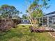 Backyard shed providing extra storage space, complemented by greenery and partial fencing at 2376 Novus St, Sarasota, FL 34237