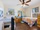 Cozy bedroom with two beds, wood floors, and natural light from the windows at 2376 Novus St, Sarasota, FL 34237