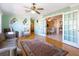 Spacious living room featuring hardwood floors, ceiling fan, stylish decor, and charming French doors at 2376 Novus St, Sarasota, FL 34237