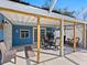 Covered patio with outdoor dining and seating with access to the backyard at 2376 Novus St, Sarasota, FL 34237