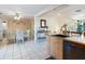 Bright kitchen open to the dining and living area, featuring a sink and wood cabinets at 2376 Novus St, Sarasota, FL 34237