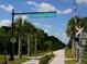 The Legacy Trail sign with a paved path, trail closure warning, and palm trees at 2376 Novus St, Sarasota, FL 34237