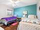 Cozy bedroom with two beds, colorful decor, and a ceiling fan at 2376 Novus St, Sarasota, FL 34237