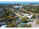 An aerial neighborhood view showing rooftops and landscaping with a cityscape in the distance at 2376 Novus St, Sarasota, FL 34237