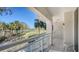 Balcony view featuring palm trees, manicured grass, and lounge seating at 250 Sands Point Rd # 5101, Longboat Key, FL 34228
