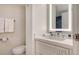 Cozy bathroom with a large mirror and a toilet at 250 Sands Point Rd # 5101, Longboat Key, FL 34228