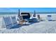 Serene beach rentals with chairs, lounges, and umbrellas facing the tranquil ocean at 250 Sands Point Rd # 5101, Longboat Key, FL 34228