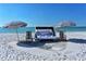 Relaxing spot on the beach with lounge seating and umbrellas, ideal for enjoying the sun and ocean breezes at 250 Sands Point Rd # 5101, Longboat Key, FL 34228