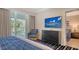 Comfortable bedroom featuring a TV, balcony, and a sitting area at 250 Sands Point Rd # 5101, Longboat Key, FL 34228