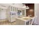 Stylish kitchen features white cabinetry, stainless appliances, and pendant lighting at 250 Sands Point Rd # 5101, Longboat Key, FL 34228