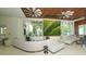 Comfortable lobby seating area with modern decor, natural light, and a vertical garden feature at 250 Sands Point Rd # 5101, Longboat Key, FL 34228