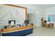 Reception desk featuring boat design in modern lobby area with unique art and nautical decor at 250 Sands Point Rd # 5101, Longboat Key, FL 34228