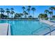 Large outdoor pool area with lounge chairs and umbrellas overlooking the ocean at 250 Sands Point Rd # 5101, Longboat Key, FL 34228
