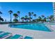 Large, clear pool area with lounge chairs and palm trees in the background at 250 Sands Point Rd # 5101, Longboat Key, FL 34228