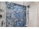 Luxurious shower features blue tile detail, glass enclosure, and modern fixtures at 250 Sands Point Rd # 5101, Longboat Key, FL 34228