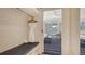 Walk in closet with bench, drawers and hanging rod to bedroom with balcony at 250 Sands Point Rd # 5101, Longboat Key, FL 34228