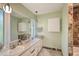 Bathroom featuring double sinks, a large mirror, and neutral decor with tile floors at 2812 Casey Key Rd, Nokomis, FL 34275
