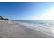 Quiet beach scene with soft waves lapping against a shell-scattered shoreline at 2812 Casey Key Rd, Nokomis, FL 34275