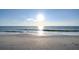 Expansive sandy beach meeting the gentle waves of a calm, sunny sea at 2812 Casey Key Rd, Nokomis, FL 34275