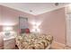Bedroom with tropical themed bedding, side tables with lamps and tile flooring at 2812 Casey Key Rd, Nokomis, FL 34275