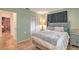Cozy bedroom showcasing a bed with gray bedding, a side table, and a closet, providing a comfortable space at 2812 Casey Key Rd, Nokomis, FL 34275