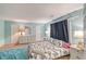 Bright bedroom showcasing a queen-size bed, stylish decor, and plenty of natural light from the windows at 2812 Casey Key Rd, Nokomis, FL 34275