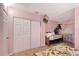 Bedroom with a closet, TV, bedside tables and leafy patterned bedding at 2812 Casey Key Rd, Nokomis, FL 34275