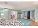 Spacious bedroom with a flat-screen TV, a connecting door and large windows, perfect for relaxation and entertainment at 2812 Casey Key Rd, Nokomis, FL 34275
