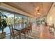 Bright dining room with ceiling fan and screen enclosed patio access at 2812 Casey Key Rd, Nokomis, FL 34275