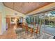 Dining room adjacent to the pool area with wood paneled ceiling at 2812 Casey Key Rd, Nokomis, FL 34275