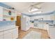 White kitchen with stainless steel appliances and breakfast bar at 2812 Casey Key Rd, Nokomis, FL 34275