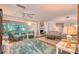Cozy living room with fireplace, plush seating, tile floors, and a large window for natural light at 2812 Casey Key Rd, Nokomis, FL 34275