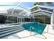 Screened pool and spa with stairs, white patio and home in the background at 2812 Casey Key Rd, Nokomis, FL 34275