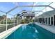 Screened-in pool featuring tiled water line, built-in steps, and a bright, open space for comfortable outdoor enjoyment at 2812 Casey Key Rd, Nokomis, FL 34275
