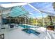 Screened pool with a hot tub, patio furniture and partially retracted awning at 2812 Casey Key Rd, Nokomis, FL 34275