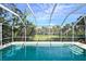 Screened pool area overlooking palm trees at 2812 Casey Key Rd, Nokomis, FL 34275