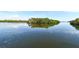 Scenic view of a calm waterway reflecting the sky, surrounded by lush greenery at 2812 Casey Key Rd, Nokomis, FL 34275