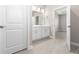 Modern bathroom featuring double sinks, white cabinets, and access to the bedroom at 3294 Gowanda Ave, North Port, FL 34287