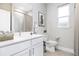 Bright bathroom featuring a vanity with quartz countertop, tile flooring, and modern fixtures at 3294 Gowanda Ave, North Port, FL 34287